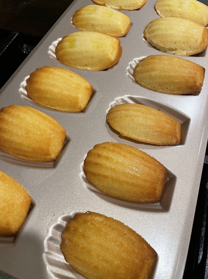 Freshly baked madeleines in a baking tray